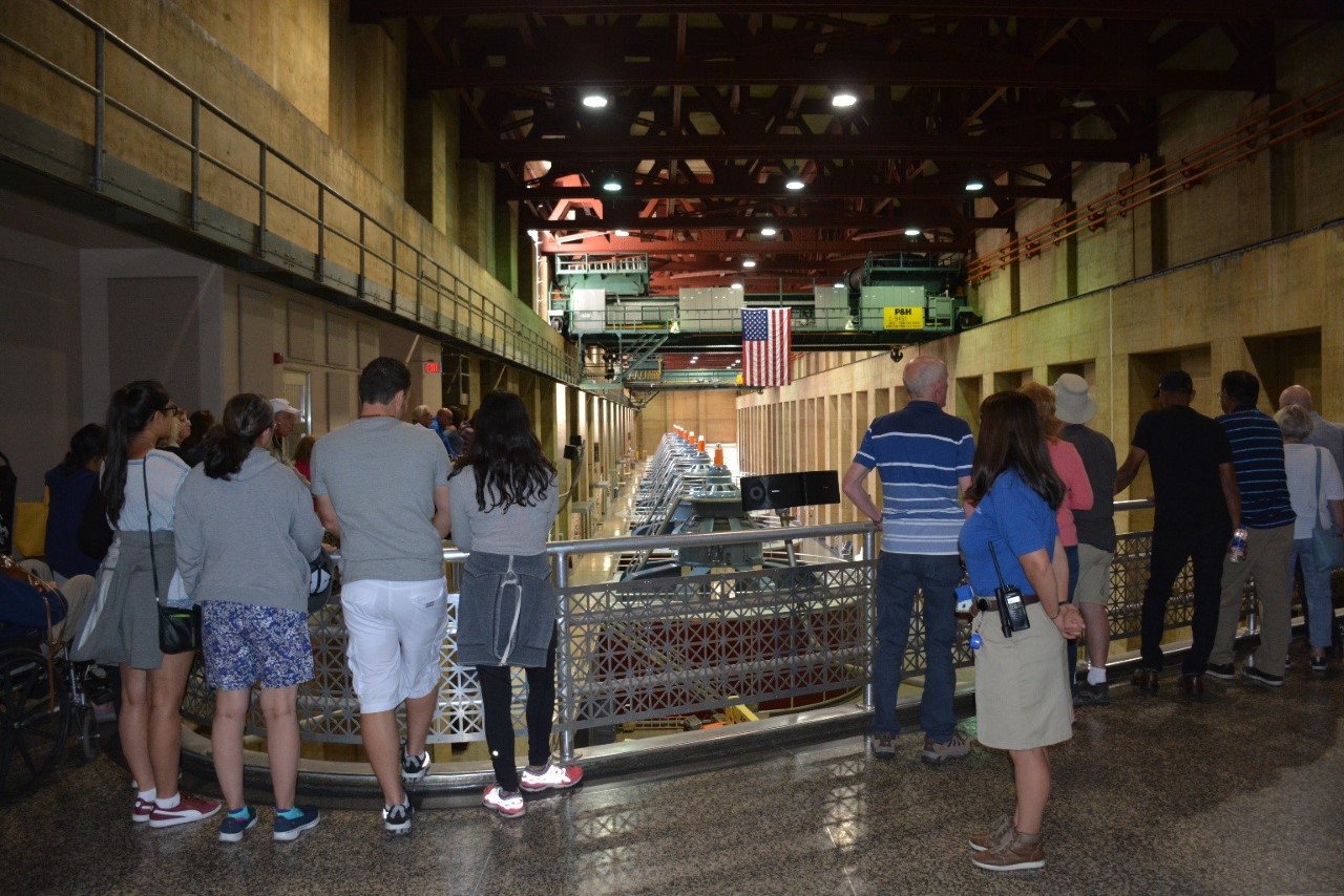 Visitors at Hoover Dam viewing the generators from the observation deck.